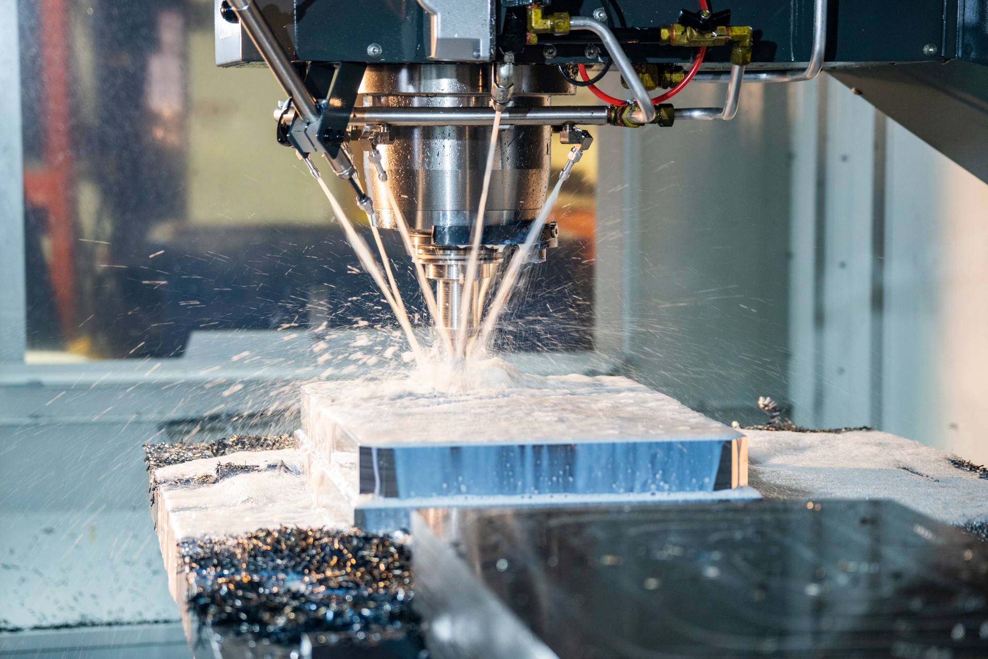 CNC Milling machine cutting steel billet