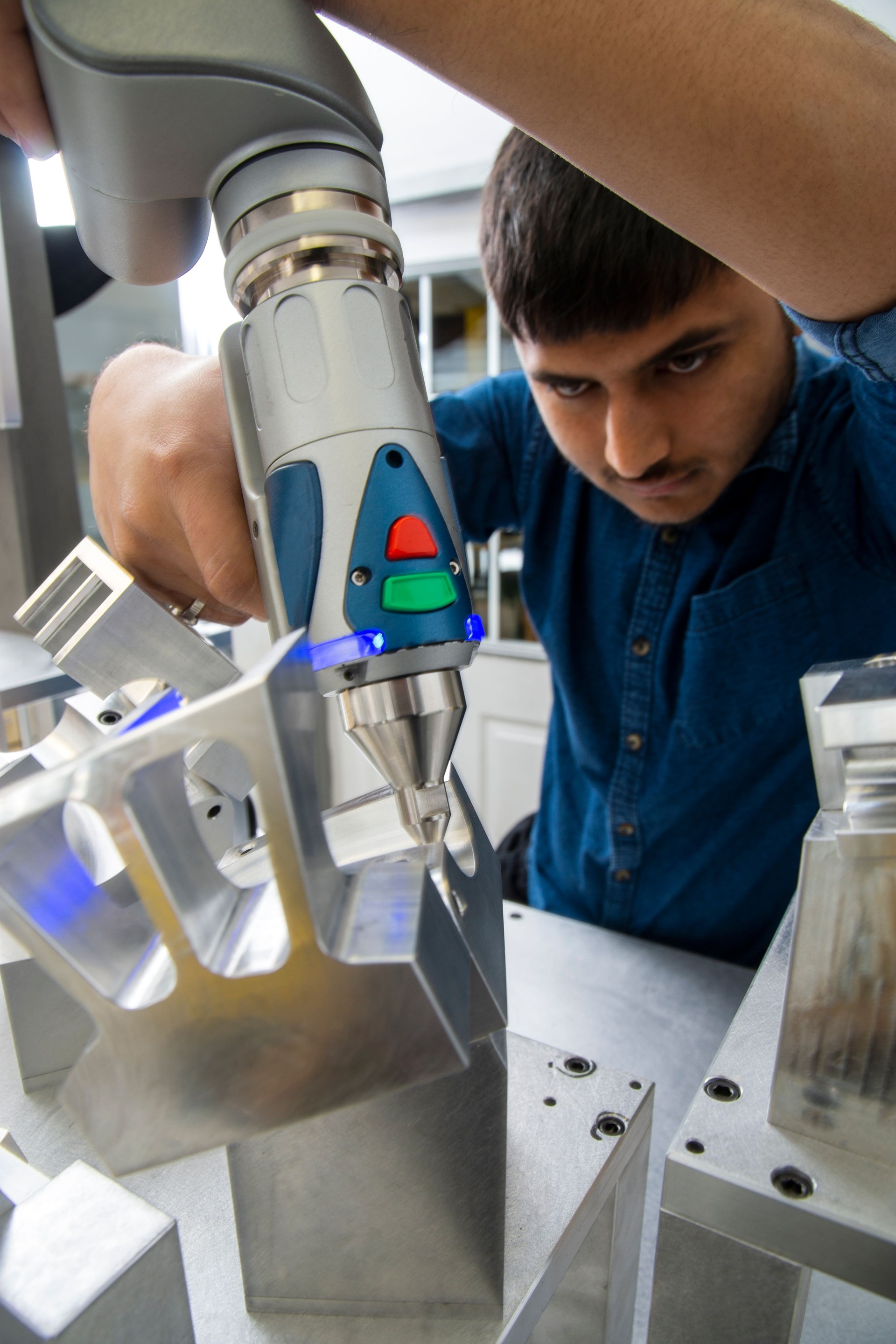 Young male engineer working in a quality control lab in a manufacturing plant.